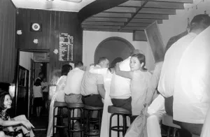 Night life in Saigon Vietnam. Local women provide company at the bar to visiting