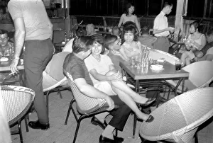 Chatting Prints: Night life in Saigon Vietnam. Local women sit on the laps of visiting men