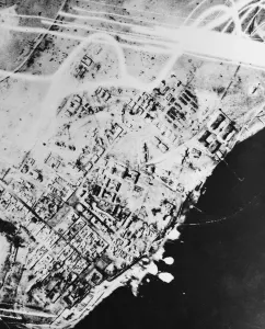 This night photographs show direct hits scored by British bombers on Tobruk jetties