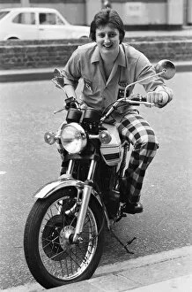 Images Dated 6th March 1977: Nineteen year old dart player Eric Bristow poses in London sitting on a motorbike