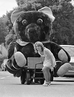 Strength Prints: Nineteen year old Elaine Maidment pulls along her giant teddy bear on a trolley through