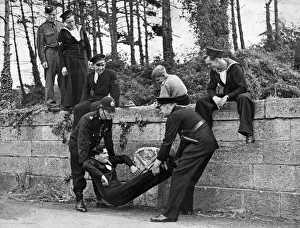 Ceremony Prints: Nineteen year old Royal Navy stoker Benjamin Brown of HMS Drake is lifted by a constable