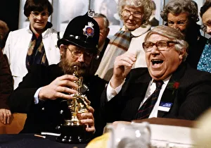 Noel Edmonds TV Presenter Game Show Host in disguise as a policeman handing out an award
