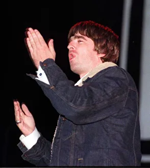 Gestures Prints: Noel Gallagher waving his hands in the air during a concert circa 1999