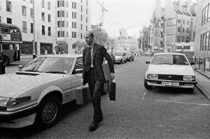 Norman Tebbit arrives with three despatch boxes at the Department of Trade, Victoria