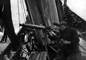 North Sea trawlerman, gunner - fisherman Liston (left) in action with a Lewis gun to