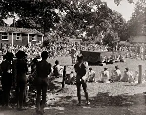 Naked Prints: Nudist Beauty Contest - August 1957 people gather round a stage to view contestants