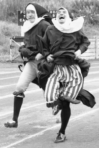 Competitive Prints: The Nuns Olympics. The 100 metre dash by two nuns in the form of left Kevin Moran