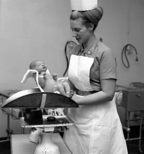 00039 Prints: Nurse Anne Stewart with first new born babies of the year at Queen Charlotte
