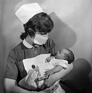 Images Dated 1st January 1973: A nurse holding a baby at Carter Bequest hospital. Circa 1973
