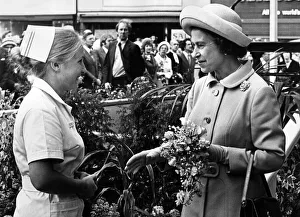 Gift Prints: Nurse Susan Laskey presents a bouquet to Queen Elizabeth II as she arrives at Stockton