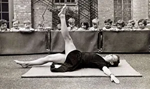 A nurse who was a dancer shows the children an exercise at the Thames Side war nursery