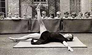 Core19 Prints: A nurse who was a dancer shows the children an exercise at the Thames Side war nursery