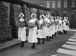 Gas Masks Prints: Nurses at Birmingham Hospital going on duty with their gas masks 5th September 1939
