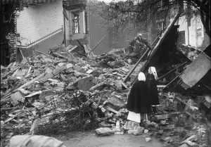 Ruins Prints: Nurses stand and look at the rubble that is now St Giles Hospital in Camberwell