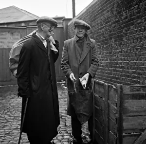 OAPs collecting firewood outside a furniture factory in Denmark Hill, London