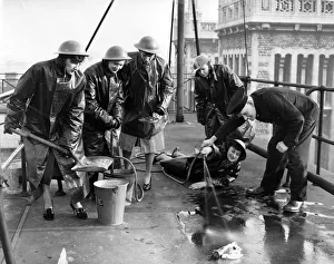 01441 Prints: Office girls on a city roof being instructed how to fight an incendiary bomb
