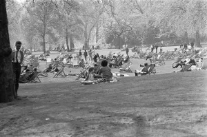 Sun Bathing Prints: Office workers and young families enjoy the spring warmth and sun in St James Park