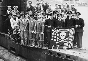 Officers and sailors of the British Submarine Ultor displaying their Jolly Roger which
