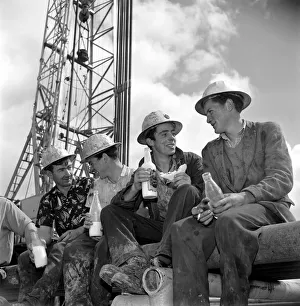 Resting Prints: Oil well drilling for oil in Ireland. Irish roughnecks enjoy a lunch break beneath
