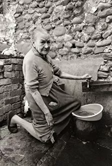 00151 Collection: Old Mary Wallace washes her dishes outside in hubert Street in Newtown cardiff