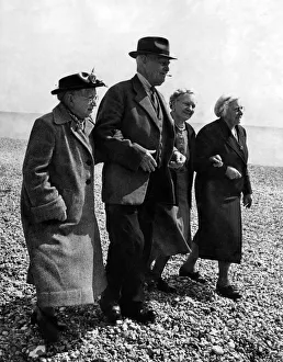 00050 Prints: Old people go for walk on the pebbled ground at a Holiday Hotel in Boxhill