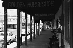 00671 Prints: Three old timers sit outside the Tombstone Drug store close to the site of the famous
