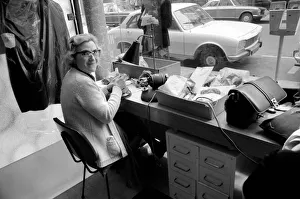 Textile Prints: An old woman mending ladders in tights at a shop near the Champs Elysees in Paris