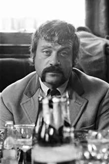 Oliver Reed, British actor, enjoys a few drinks at his local pub, The Dog and Fox