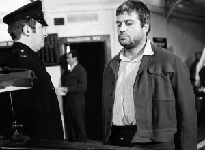 Frowning Prints: Oliver Reed British actor in film Sitting Target 1971 in jail facing prison
