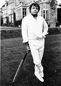 Oliver Reed Film Actor awaits his turn to bat in the grounds of a stately home
