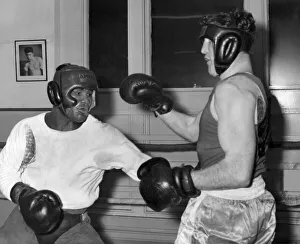 Protective Clothing Prints: Ouch ! That hurt, grunts Allan Hands of Blackpool as Joe Bygraves of Birkenhead digs home
