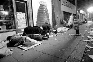 Down and outs sleep rough under the arch of the back entrance of Charing Cross Station