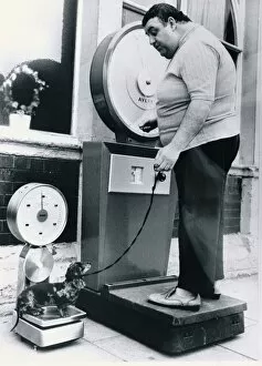 Images Dated 1st June 1989: An overweight owner weighs himself on a set of Avery scales