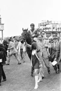 Owner Frank Spencer leads in Fiery Coin and jockey Cliffe Parkes after winning the Andy