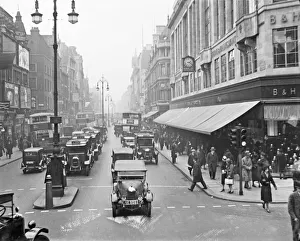 Advertising Prints: Oxford Street, London. A busy scene with cars and pedestrians