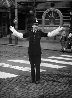 P. C. Gibbs of the Manchester Police seen here on crossing patrol on the day he retires