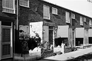 01083 Prints: Painted council houses and the unpainted ones - part of a battle of home buying at a