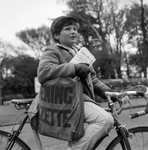 Paperboy Alan Preston delivering the Daily Telegraph in Lytham St Annes, Lancashire