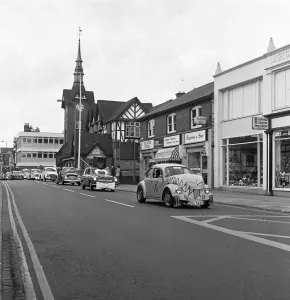 A parade of cars led by a decorated VW Beetle drive along Bridge Street, Stafford