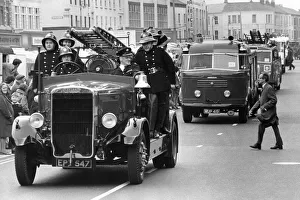 A parade of fire engines past and present - one man appears unimpressed as he tries to
