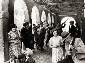 00190 Prints: Parashooters of a Midland village assemble in the ancient market hall