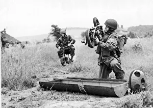 Scooter Prints: Paratrooper assembles his folding motor scooter - a. k. a