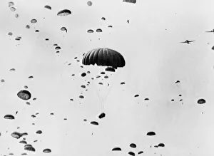 Paratroops drop earthward during landing in Holland by 1st allied Airborne army as