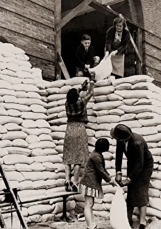 Parents and children help sandbag the main entrance to the Manchester Grammar School