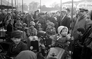 00169 Prints: Parents watch as their children ride on a merry-go-round at Blackheath Fair April