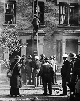 Wounded Prints: A party of rescue workers part of the ARP seen here checking houses damage by blast for