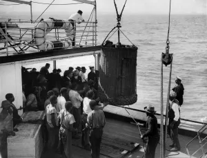 Passenger Prints: Passengers come aboard in basket owing to sea being too rough for use of companion ladder