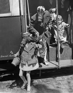 Passengers disembark from a bus wearing their gas masks during an ARP exercise