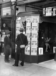 Gas Masks Prints: A passer-by look at a tailor shop window plastered with copies of the Daily Mirror Hitler